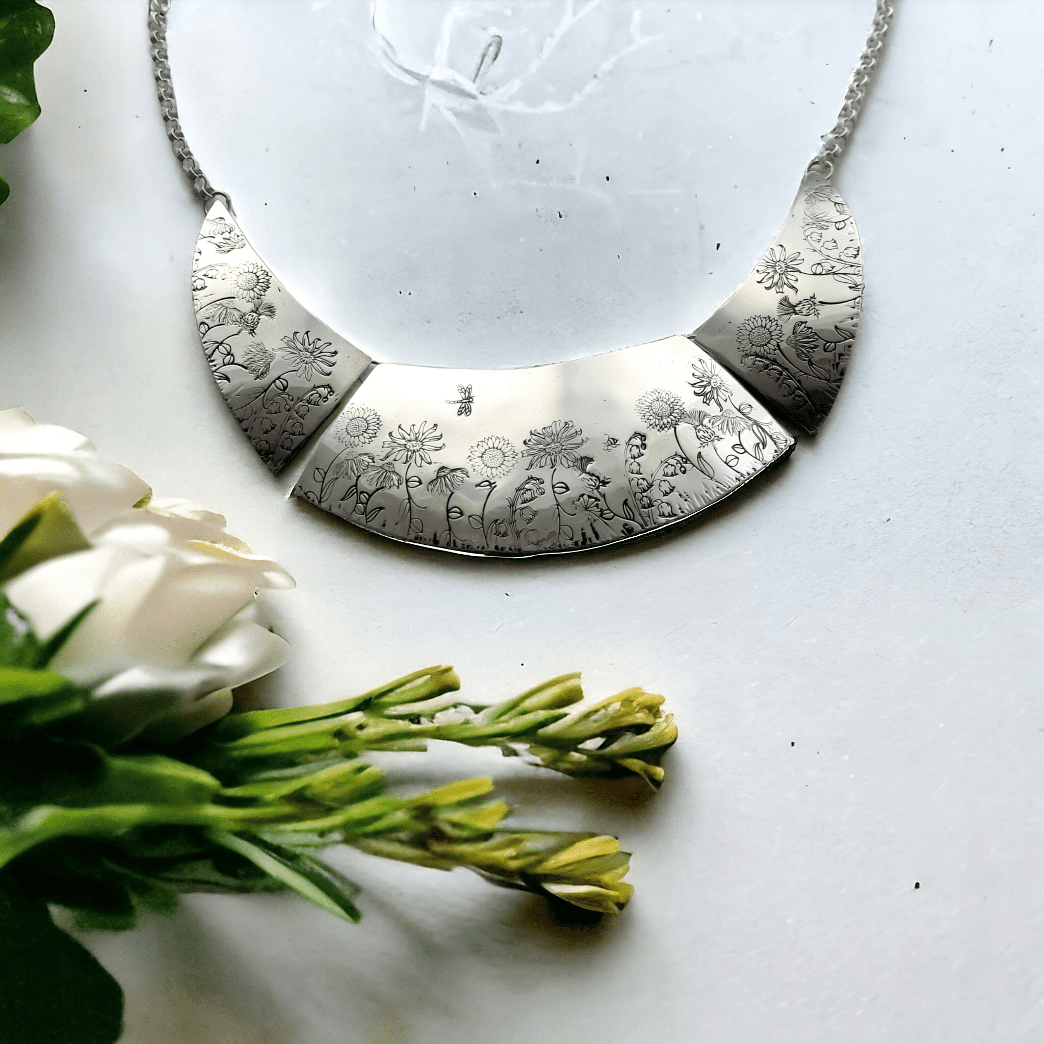 statement necklace with cottage garden flowers on in silver