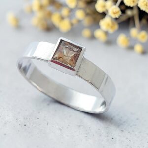 Princess cut citrine set in a textured silver ring